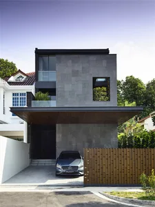 Modern architectural design featuring a contemporary residential house with concrete exterior and large windows.