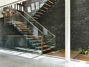 Modern staircase with glass railings and metallic steps.
