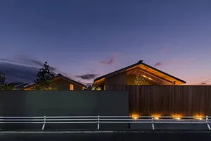 A minimalist house with wooden exterior at dusk.
