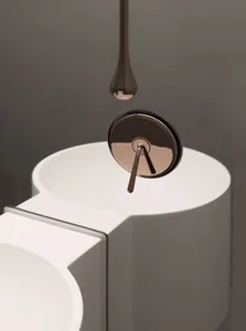 Close-up of a modern white bathroom sink with a ceramic faucet.
