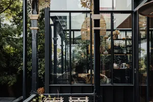 Modern coffee shop with large glass windows showcasing contemporary design elements and natural light.