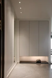A minimalist entryway with modern design features and concrete flooring.