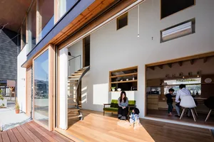 A modern residential interior with contemporary design elements, featuring a mix of wood, glass, and white paint materials.