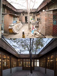 An interior view of a restored old house with wooden walls and flooring, showcasing modern design elements.