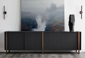 Contemporary black wooden and metal sideboard with minimalist design, featuring abstract artwork and wall sconces.