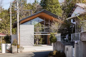 A modern house with a combination of concrete and glass exterior materials.