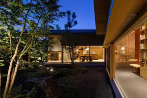 Modern residential interior featuring wooden furniture and a well-lit living area.