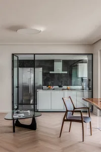 A modern residential kitchen featuring glass cabinets and a sleek design.