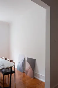 A minimalist interior design featuring painted surfaces and modern furniture.