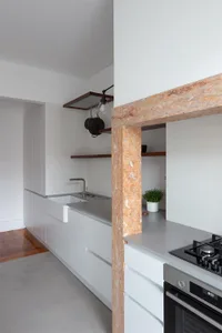 Modern kitchen featuring white cabinets, gray countertops, and a sleek, minimalist design.