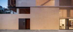Modern building with exterior tiled facade showcasing clean lines and geometric patterns.