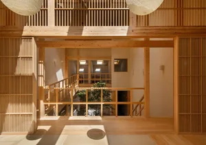 Minimalist living room with wooden flooring and furniture.