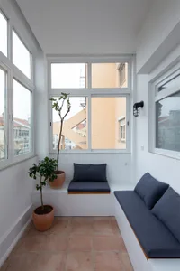 A modern living room with concrete walls and furniture.