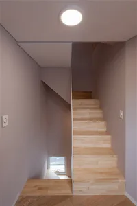 Minimalist architectural staircase with wooden steps and simple, clean lines.