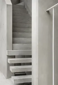 Modern, minimalist concrete staircase with clean lines and industrial aesthetic.