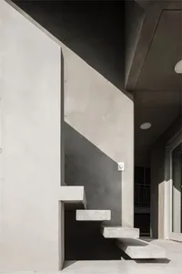 Concrete stairs leading up to a modern building exterior.