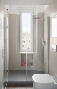 Modern minimalist bathroom with a glass shower enclosure and a pink flamingo.