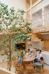 A modern residential space with wooden materials and a tree in the center.