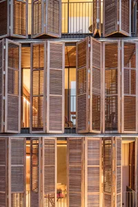 Modern wooden shutters covering a building exterior.
