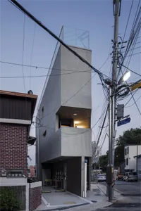 Modern architectural structure made of concrete with glass elements on a street