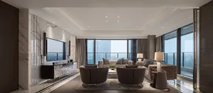 Modern living room featuring marble walls and leather furniture