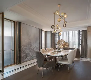 Modern dining room with marble table, glass pendant lights, and metal chairs