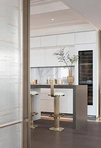 Modern kitchen featuring a concrete and marble island bar with sleek metallic stools and a vase plant decoration.