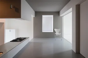 Modern minimalist interior design featuring white materials and open space.