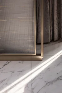 Modern bedroom with marble flooring and glass window treatments.