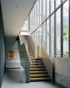 A modern industrial staircase featuring metal and wood materials.