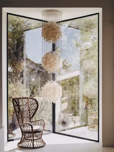 A modern wooden chair with a glass window in the background.