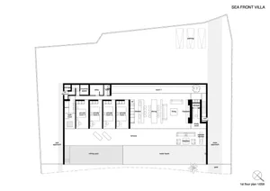 First floor architectural plan of a sea-front villa showing rooms, amenities, and layout.