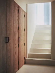 A modern staircase with wooden and concrete steps and floors.