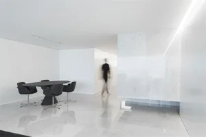 A minimalist office space featuring a marble floor plan.