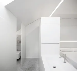 Modern white concrete bathroom suite featuring a sleek design and minimalistic style.