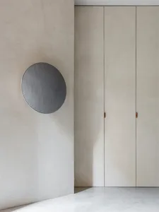 Sparse minimalist room featuring concrete finishes and simple design elements.