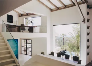 Modern residential interior with concrete, wood, and glass elements.