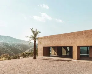 Modern residential building with concrete exterior and glass window.