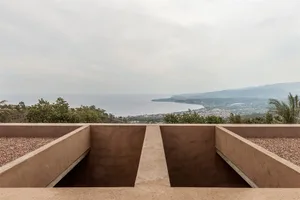 A view of mountains and a body of water from a raised vantage point.