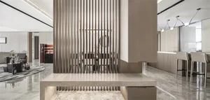 Minimalist interior design featuring marble countertops, wooden furnishings, and metallic accents.