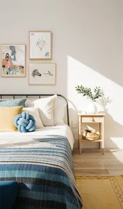 Bedroom with minimalist design, featuring blue and white textiles on the bed, wooden nightstand, and framed artwork on the wa