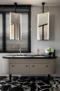 Modern bathroom featuring a double vanity with a marble countertop and black marble flooring.