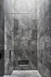 Modern bathroom interior with marble walls and floor.