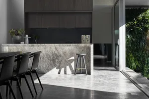 A modern kitchen featuring a marble bar countertop.