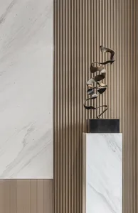A modern metal sculpture displayed on a marble pedestal against a wooden panel background.