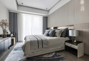 A modern minimalist bedroom featuring textured patterns on the bedding and curtains.
