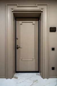 A modern minimalist doorway with a white marble floor and a metal-framed door.