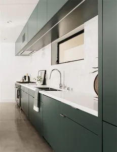 Modern dark green kitchen cabinets with white countertop and white tile backsplash.