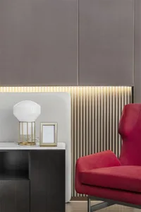 A sleek, minimalist desk with a red armchair.