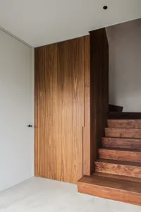 Modern interior design featuring a staircase with wooden flooring.